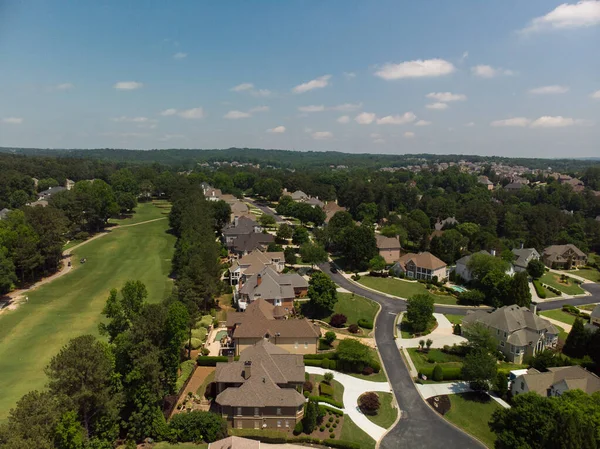 Aerial panoramic view of house cluster in a sub division in Suburbs with golf course and lake in metro Atlanta in Georgia ,USA shot by drone shot during golden hour.