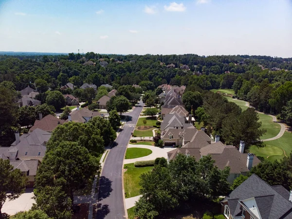 Aerial panoramic view of house cluster in a sub division in Suburbs with golf course and lake in metro Atlanta in Georgia ,USA shot by drone shot during golden hour.