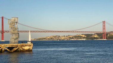 A panoramic view of famous Ponte 25 de Abril bridge in Lisbon over river Tagus in Portugal
