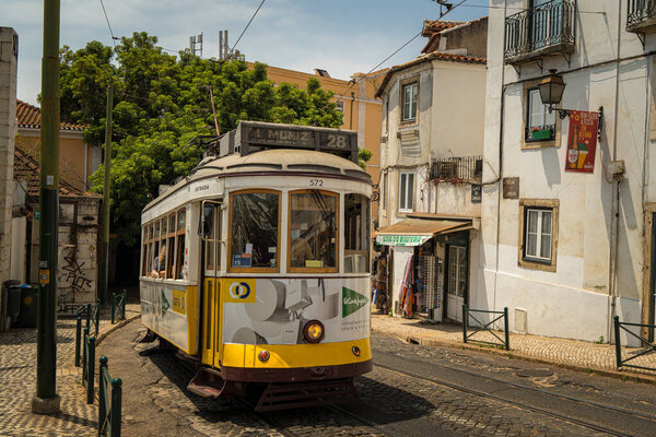 Lisbon, Portugal- July 4,2022; Famous yellow vintage tram on the street in Lisbon, Portugal. Famous travel destination
