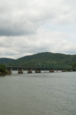 A panoramic view of Bethany bridge over lake Allatoona with locals fishing and pursuing recreational activities in the lake during summer of 2022
