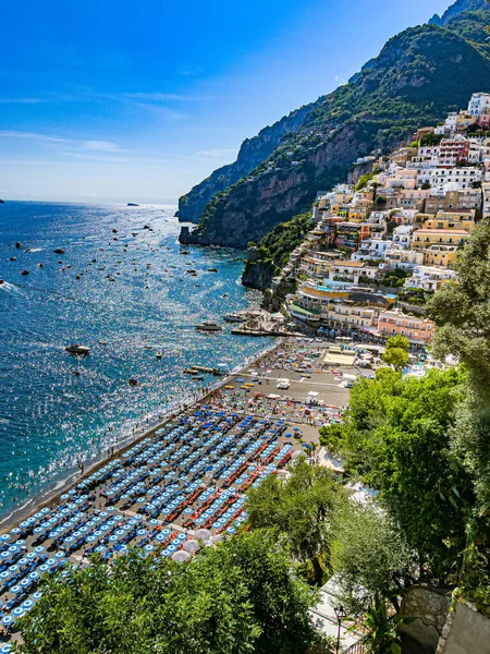 Panoramic view of Positano, Mediterranean Sea ,boats and people relaxing on the beach during summer of 2022