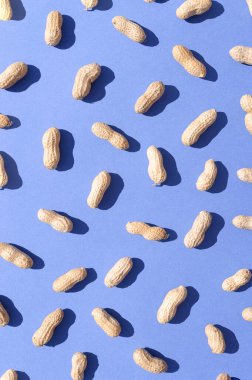 Koyu mavi arka planda çiğ fıstık. Sağlıklı gıda konsepti. Çatlak duvar kâğıdı.