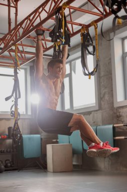 Spor salonunda spor yapan genç bir adam.