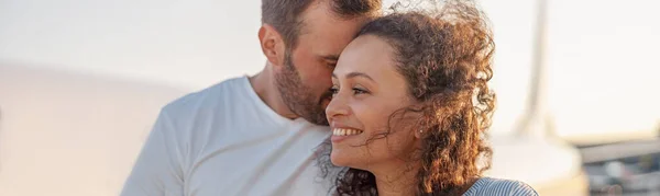 Portrait de charmant couple de touristes, homme et femme regardant heureux tout en se tenant à l'extérieur prêt pour l'embarquement à bord de l'avion au coucher du soleil — Photo