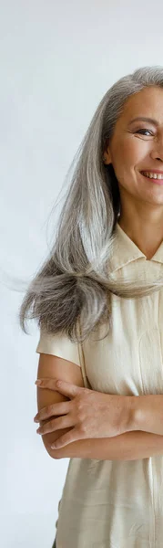 Portret van Aziatische vrouw model met lang grijs haar en gekruiste armen op lichte achtergrond — Stockfoto