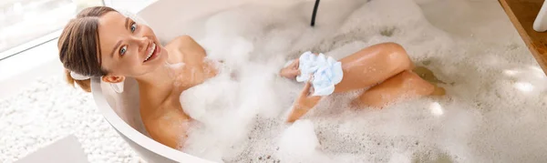 Beautiful young woman bathing with pleasure while spending time at luxury spa resort — Stock Photo, Image