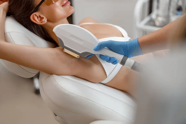 Armpit hair photo epilation procedure with ipl machine in a beauty salon
