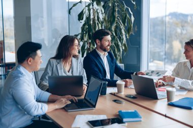 Corporate business team and manager in a meeting room at modern office with panoramic windows