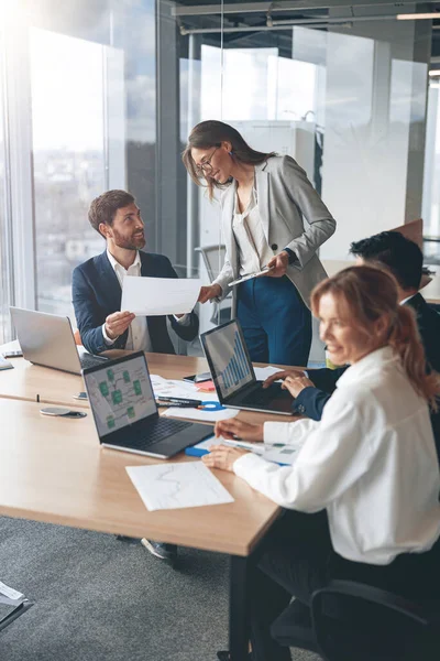 Beautiful business people are using gadgets, talking and smiling during the conference in office — Stock Photo, Image