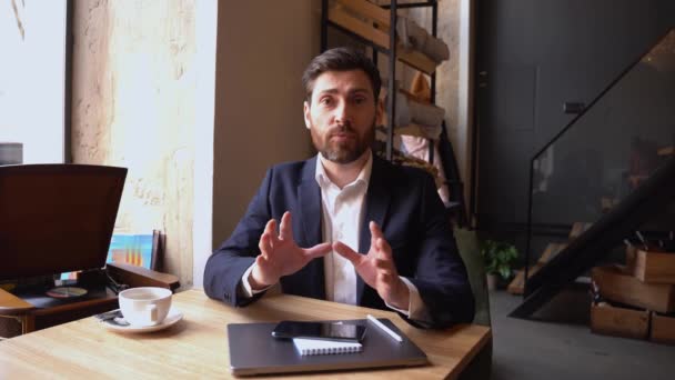 Homme d'affaires joyeux vlogger dire quelque chose à la caméra dans le café et expliquer. Coach d'affaires. — Video