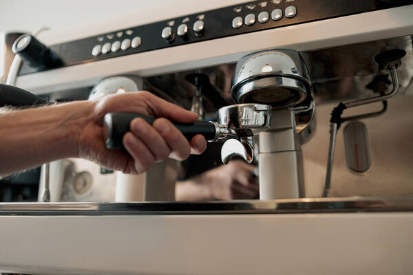 Process of pouring ground coffee into the filter