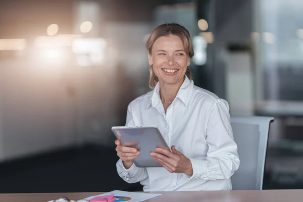 Smiling Businesswoman Glasses Holds Digital Tablet Looks Away Modern Office — 스톡 사진