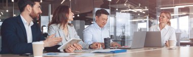 Confident and successful team. Group of modern people are working together in office.