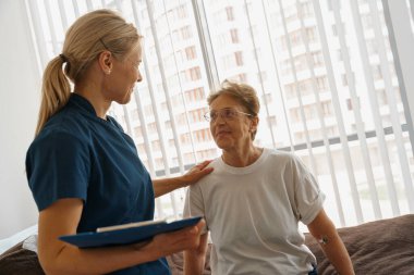 Doctor supporting a sick patient before medical procedures in a hospital ward. High quality photo