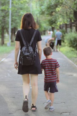 Mom and son walk in the park