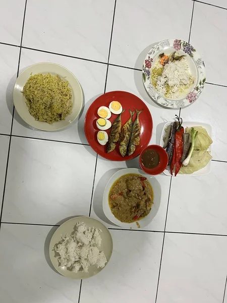 Yanında haşlanmış sebze, haşlanmış yumurta, kızarmış balık ve pilav..