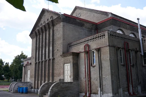 Rakovnik, Czech Republic - July 2, 2022 - modernist building from 1914 with a facade of white unplastered brick - Sokolovna - on a sunny summer afternoon                               