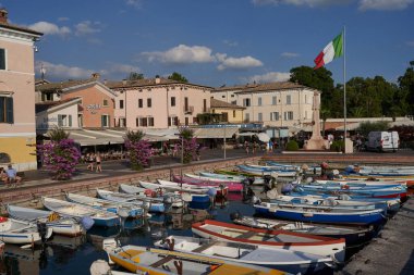 Bardolino, Italy - July 11, 2022 -  One of the biggest and most beautiful harbors on Lake Garda - Bardolino - on a summer afternoon                               