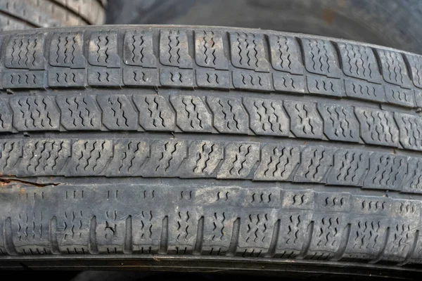 Old car tires, a pile of old car tires, a dump of worn-out tires from used cars. Environmental pollution. Throw away the tires,