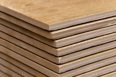 A stack of gray ceramic tiles for the floor or wall, close-up.