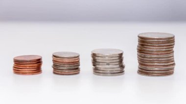 stop motion reduces the stack of coins on a white background, the general plan. Concept: falling incomes, financial crisis.