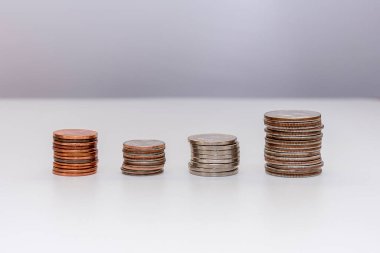 small American coins lie in piles on a light background