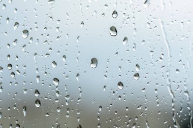 large raindrops on the window glass, rainy weather