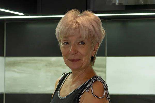 portrait of an elderly woman 60 65 years old Dark tone in the kitchen
