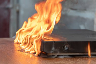 A DVD player on the table burst into flames, a melted case, a fire in the apartment.