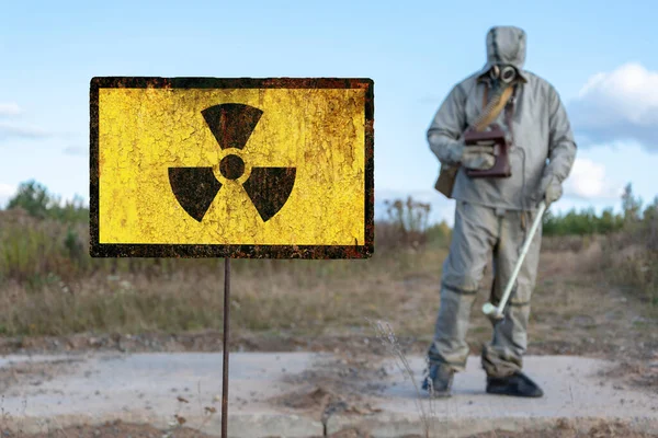 Old textural sign of radiation hazard, military chemical reconnaissance measures the level of radiation against the background of contaminated nature.