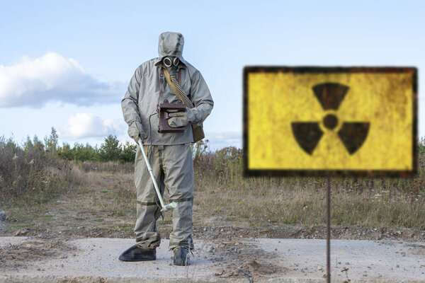 military chemical reconnaissance measures the level of radiation, Old textural Sign of radiation hazard, against the background of infected nature.