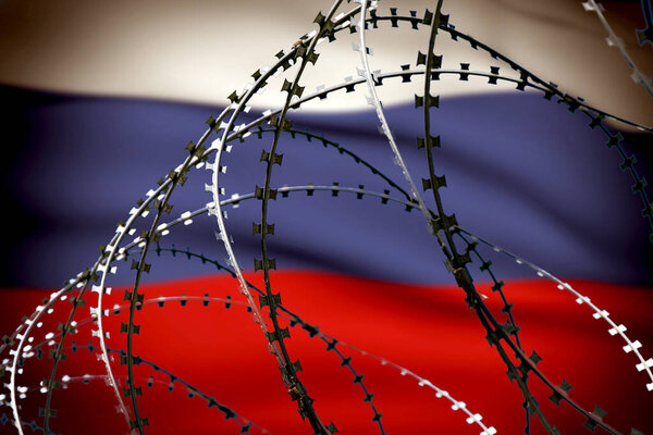 The Russian flag behind barbed wire. Concept: aggressor country, military conflict, 