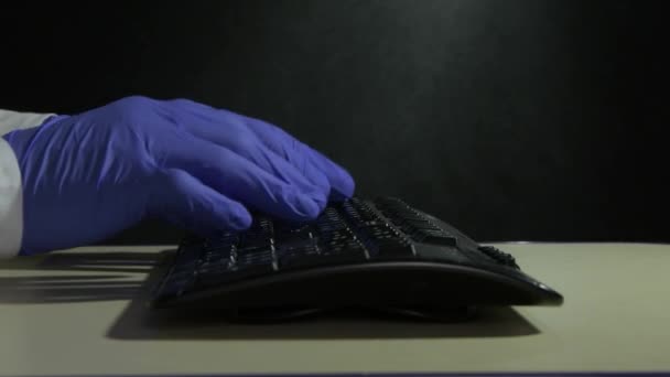 Male Doctor Typing Computer Keyboard Blue Medical Gloves Dark Background — Stock Video