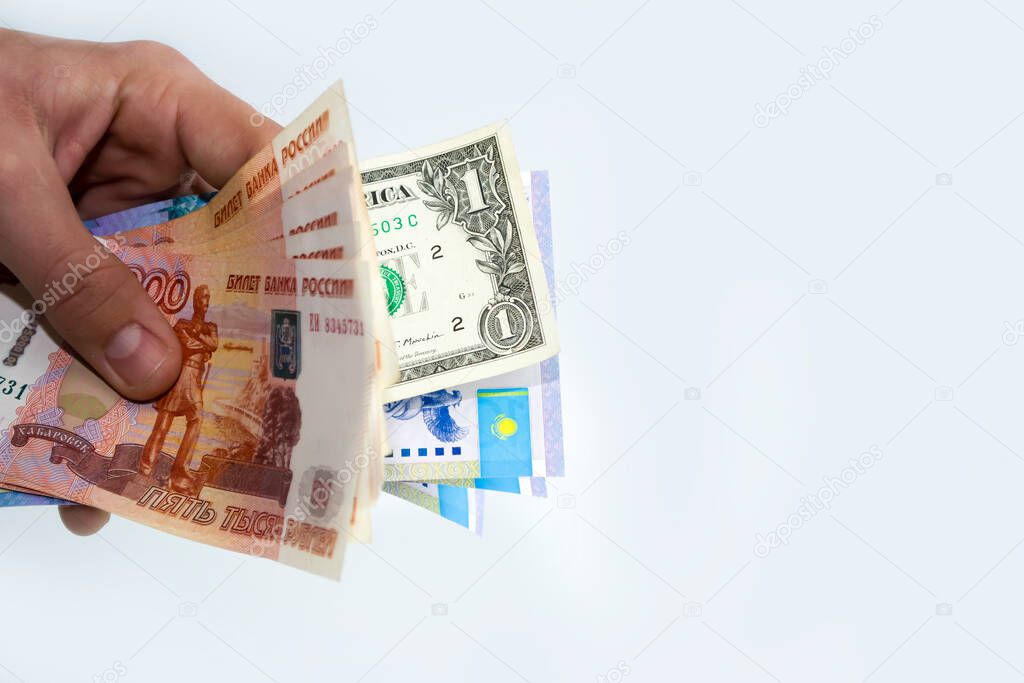 In the hands of the currency of different countries, the ruble, the dollar, tenge.