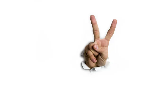 Рука жест, щоб побачити два пальці зверху через отвір на білому тлі . — стокове фото