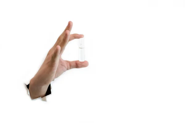 In the hand, an ampoule with the medicine on a white background. — Stock Photo, Image