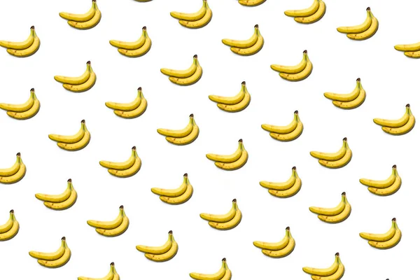 Ein Bananenmuster auf weißem Hintergrund, ein Bündel Bananen. — Stockfoto