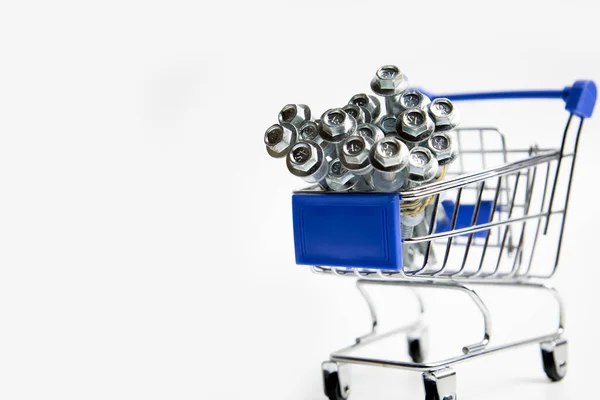 Shopping cart trolley packed with screws illustrating shopping for hardware items — ストック写真