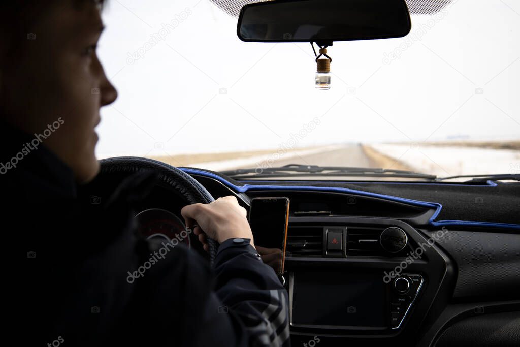 Man looking straight driving a car on the road