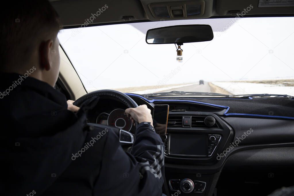 Man looking straight driving a car on the road