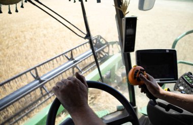 View from the combine cabin, harvesting. High quality photo