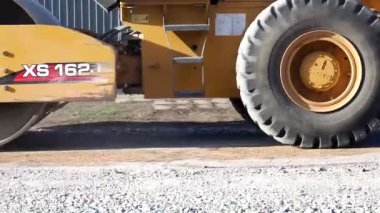 The roller compacts the gravel, preparing the ground for the road. Repair of rural roads in Northern Kazakhstan rn G. Musrepova. 04.05.2022 High quality photo