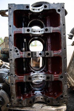 A four-cylinder engine dissembled and removed from car on a workbench in a vehicle repair workshop. Auto service industry. High quality photo