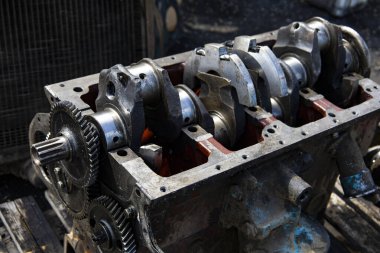 A four-cylinder engine dissembled and removed from car on a workbench in a vehicle repair workshop. Auto service industry. High quality photo