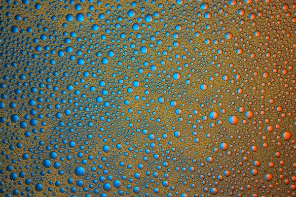 Streszczenie niebieskie i pomarańczowe bańki wody tło. Tekstura makro. — Zdjęcie stockowe