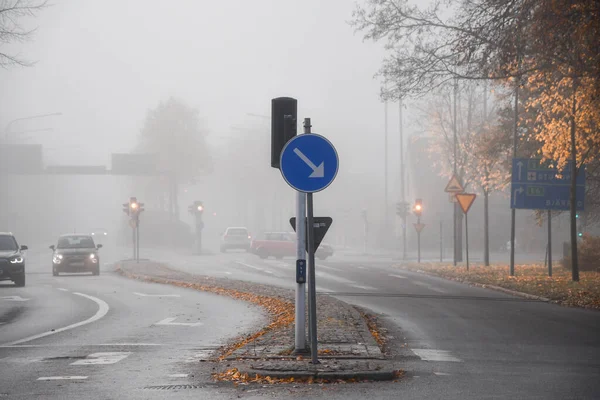 Photo of a road or street during foggy weather in autumn or fall season