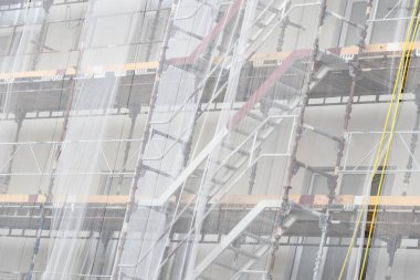 Full frame photo of an apartment complex getting renovated and improved by construction site workers