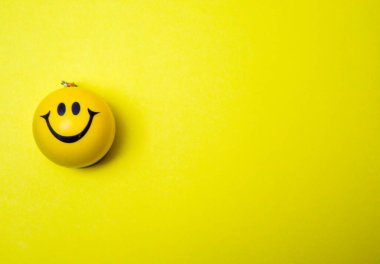 Photo of a yellow smiley face on yellow background