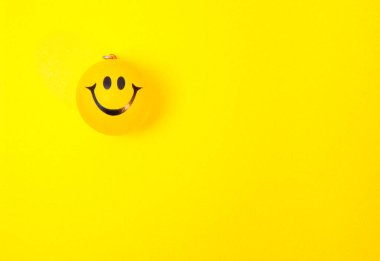 Photo of a yellow smiley face on yellow background